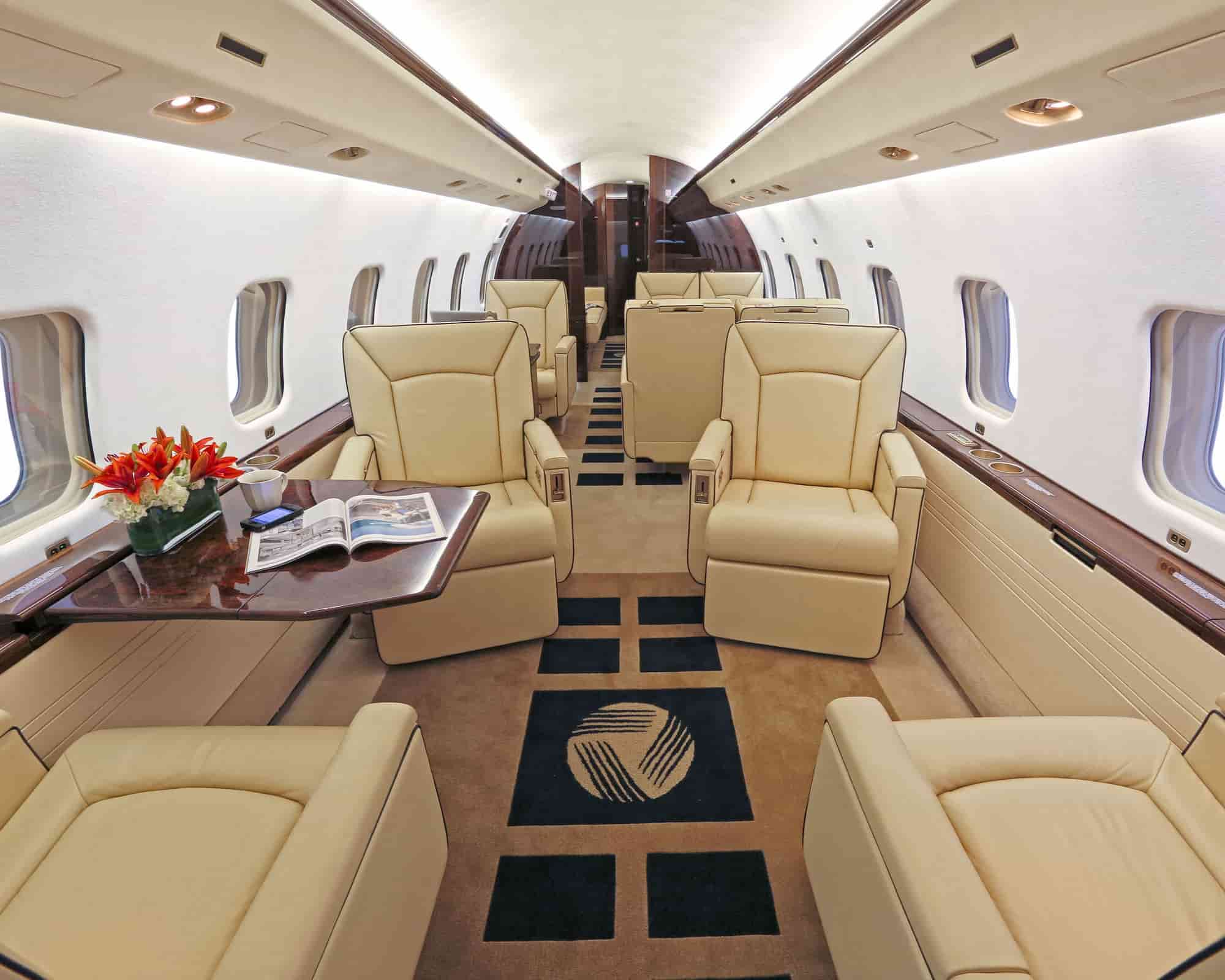 luxurious interior in the airplane with goldy color sofa and clean
